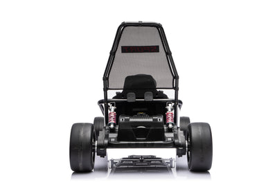 Black Outlaw Edition kids electric go-kart with child riding outdoors on driveway